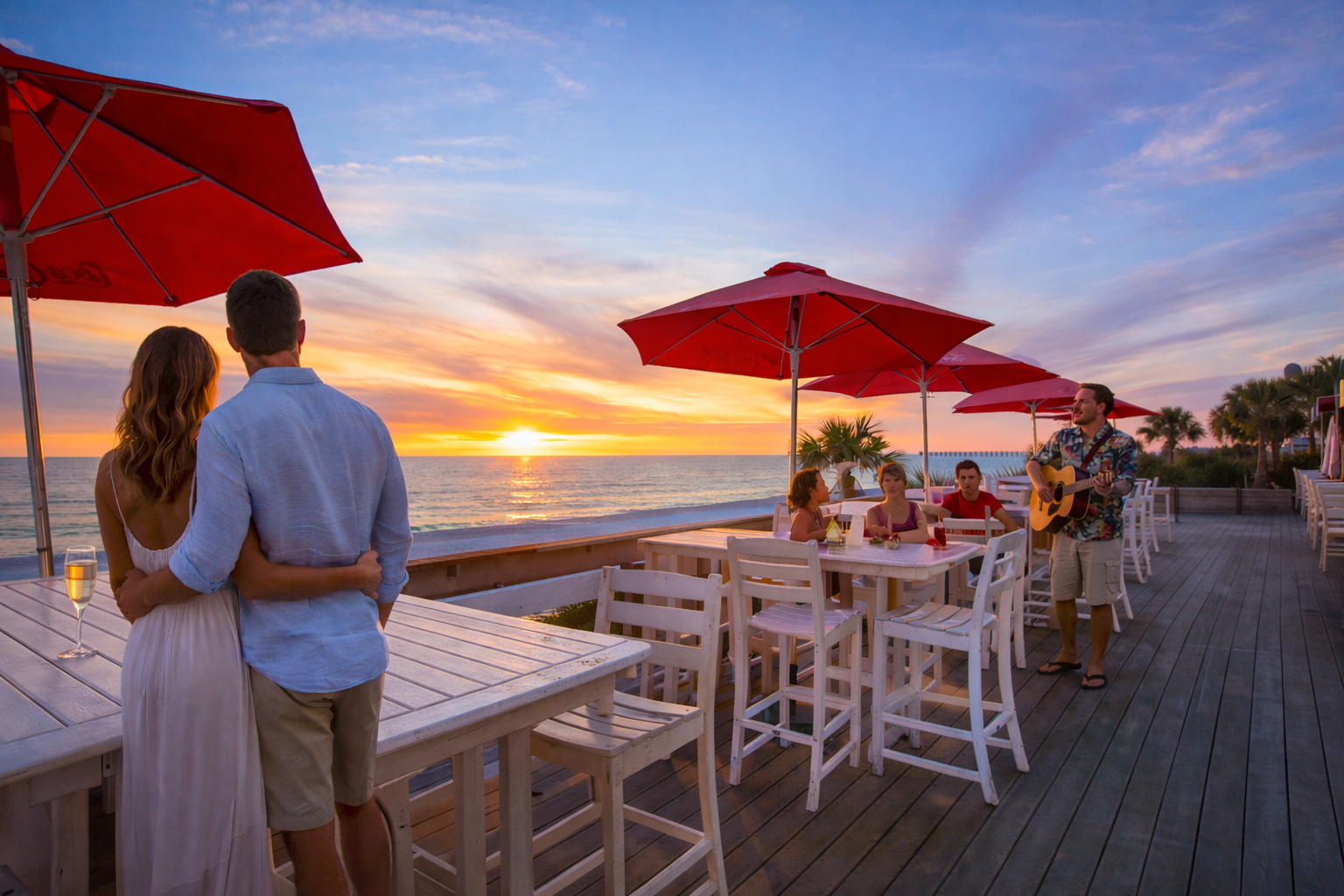 Couple enjoying a sunset at Barefoot Restaurants, while live music entertains dining guests.